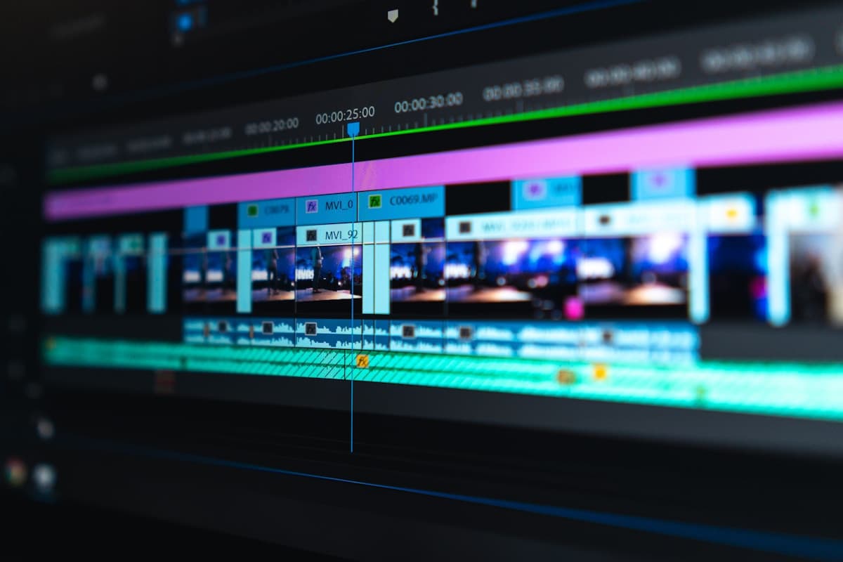 Video editing timeline on a dual-monitor workstation showing color grading